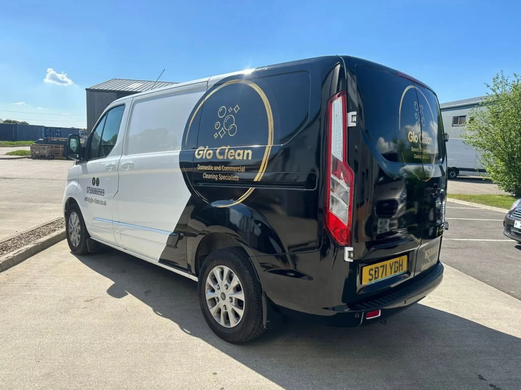 Glo Clean branded white and black van parked in a York industrial estate showing company logo and contact details