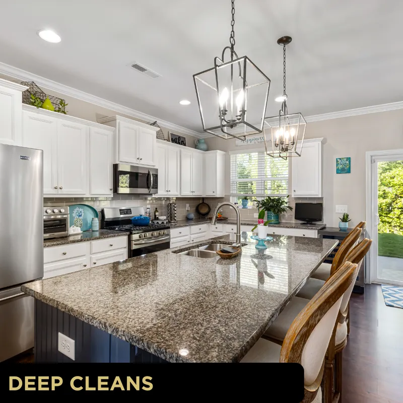 Bright, spotless kitchen with granite island, white cabinetry and stainless appliances for Glo Clean deep cleaning in York