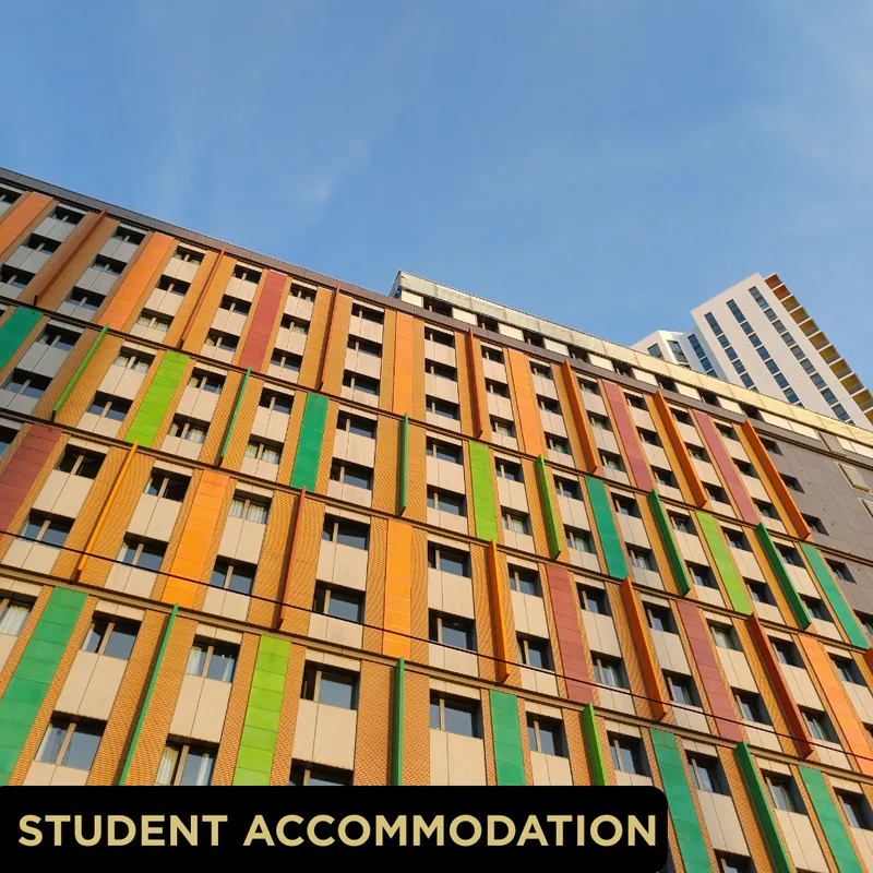 Colourful multi-storey student accommodation block in York photographed from below against a blue sky, Glo Clean caption